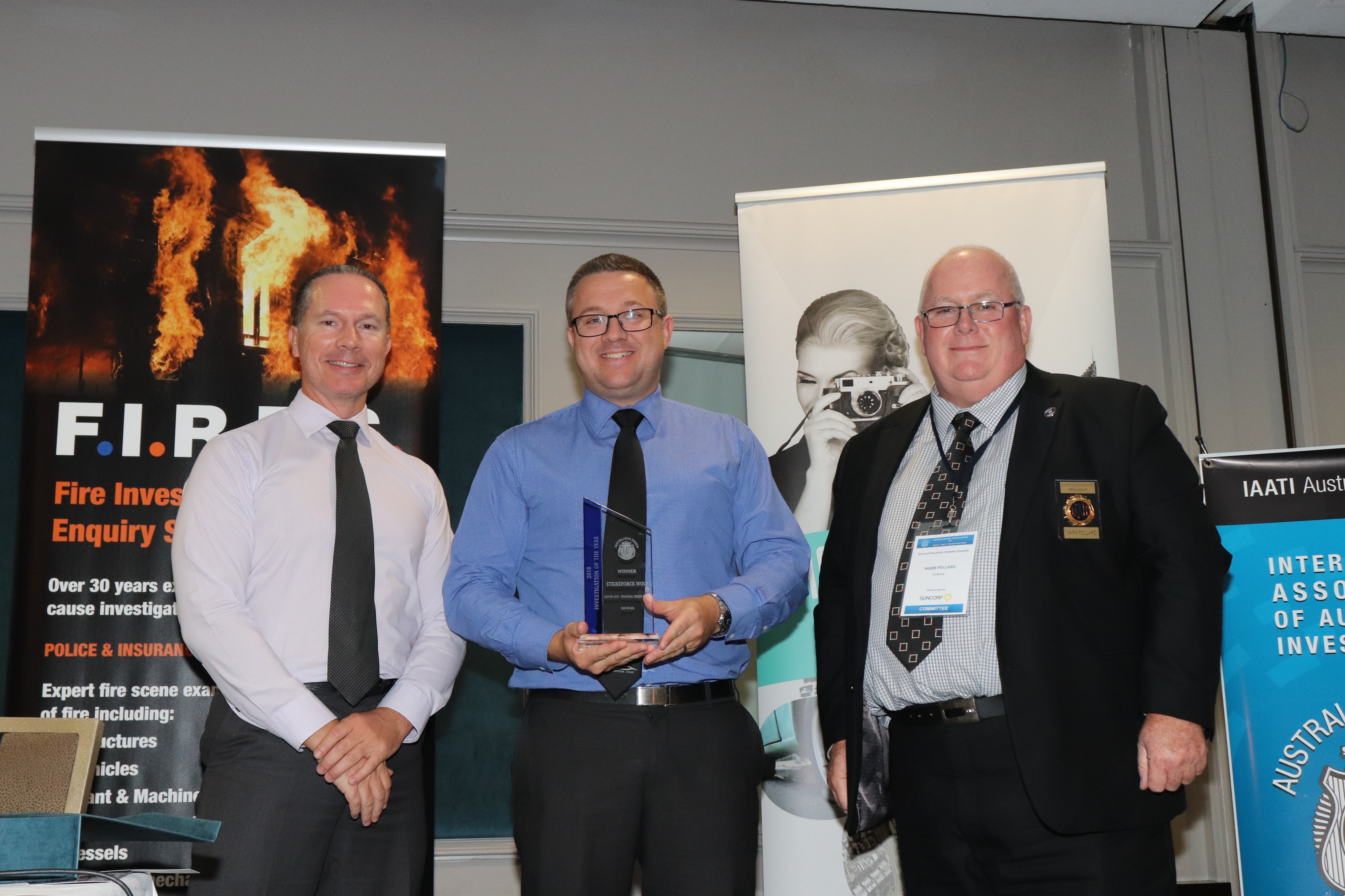 DSgt Michael BOURKE and DSC Nicholas SCOTT accepting the Investigation of the Year award from President Mark Pollard, on behalf of members of  Strike Force Wolf – New South Wales Police